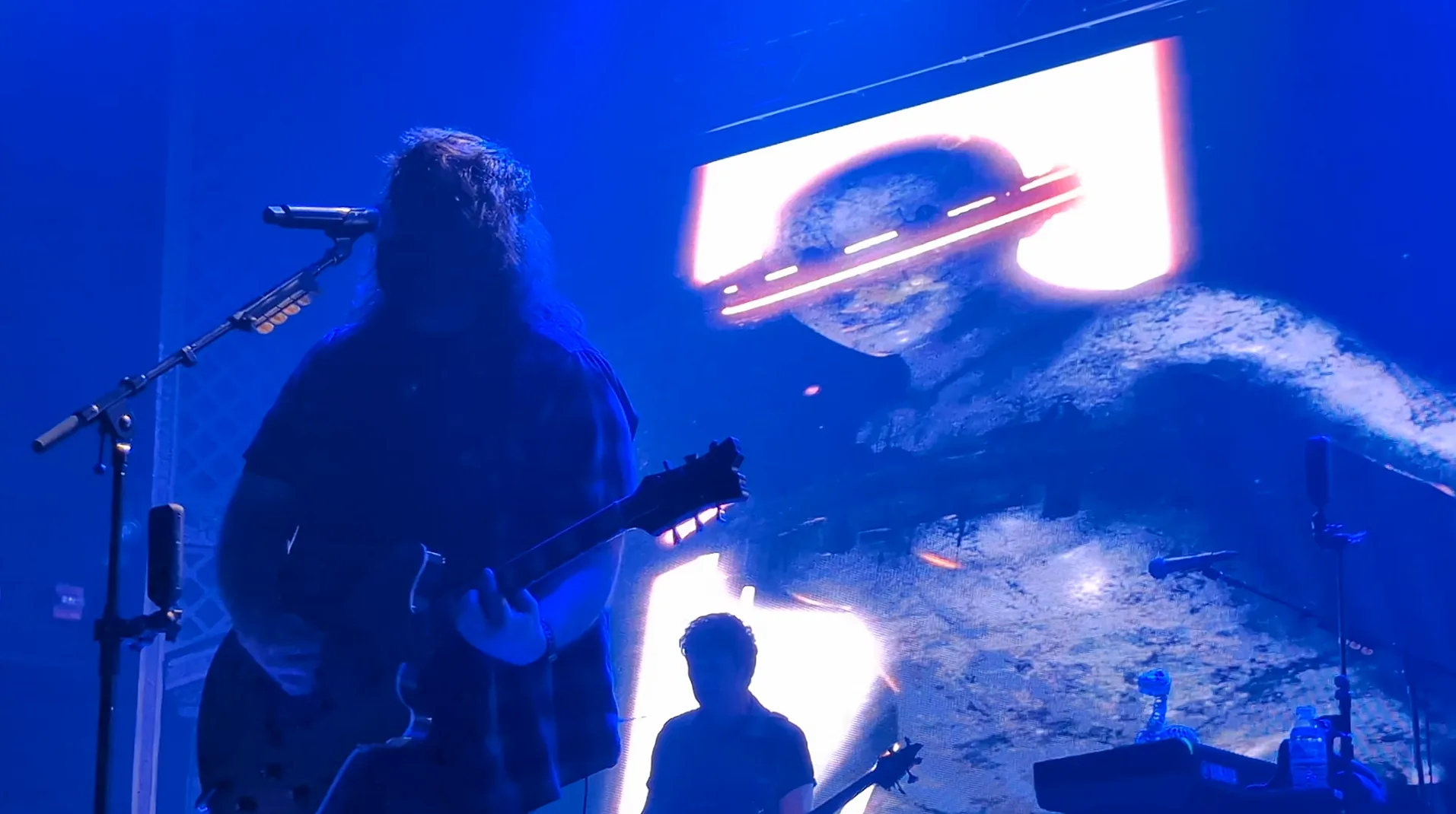 Mammoth WVH performing in front of vivid blue live visuals